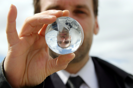 man looking through crystal ball