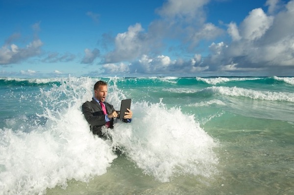 businessman using tablet in ocean