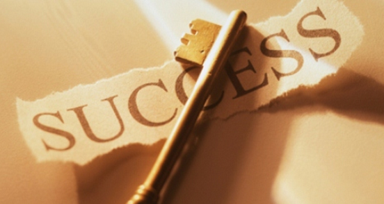 a key on top of paper with success on it