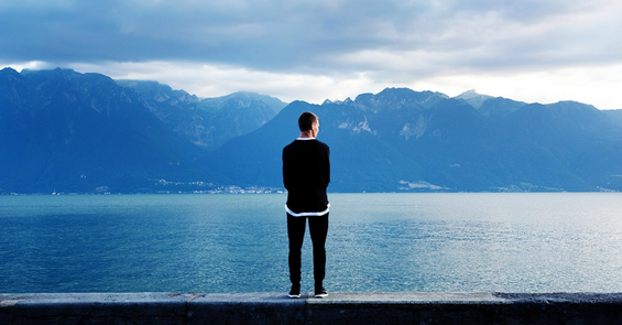 man standing in front of water