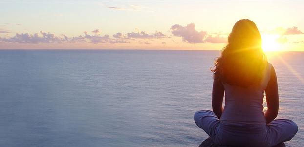 Woman sitting near ocean