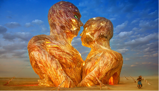 burning man statue with people dancing