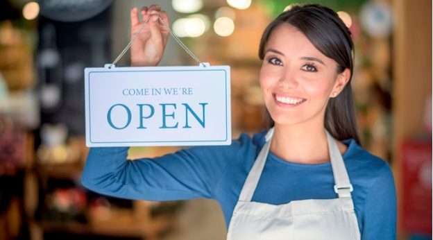 woman holding come in sign