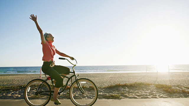 woman riding a bike near beach