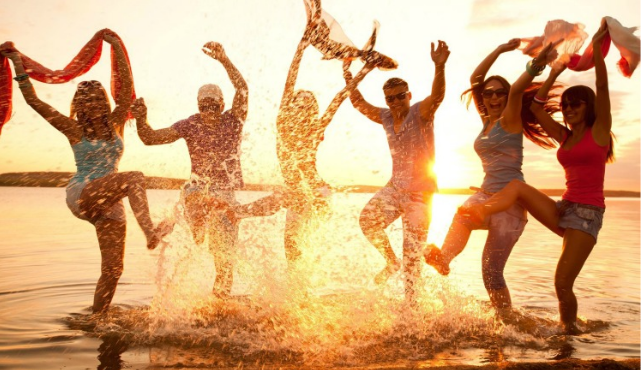 group of people in water during sunset